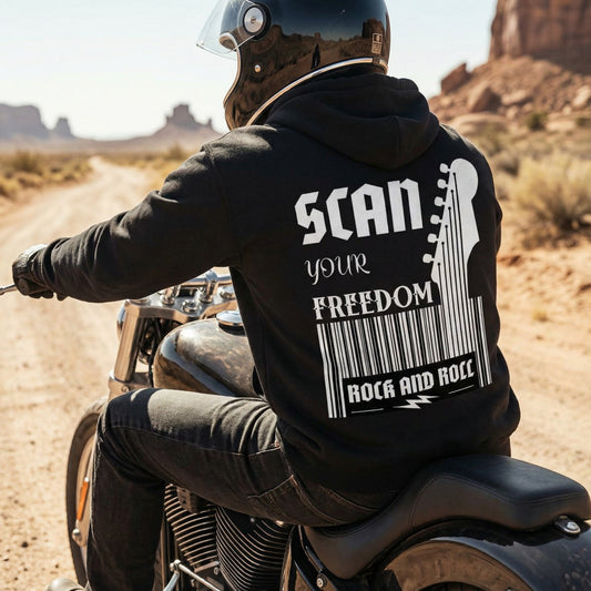 Person on a motorcycle wearing a hoodie with 'SCAN your FREEDOM ROCK AND ROLL' text in a desert setting--ayrini-studio