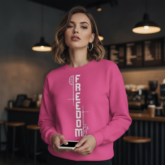 Woman wearing a pink sweatshirt with 'FREEDOM' text. Ayrini Studio